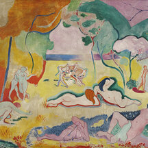 A painting of many nude figures outdoors. Some stand, while others crouch or recline. In the background, several hold hands, forming a circle. In some cases, the scale of the figures seems inconsistent with their positioning in space. The work is characterized by bold colors, many of which are not naturalistic. 