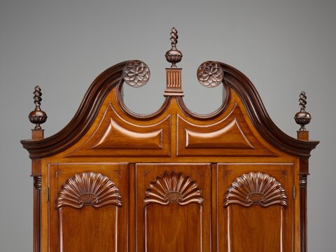 Detail of facade of mahogany desk and bookcase.