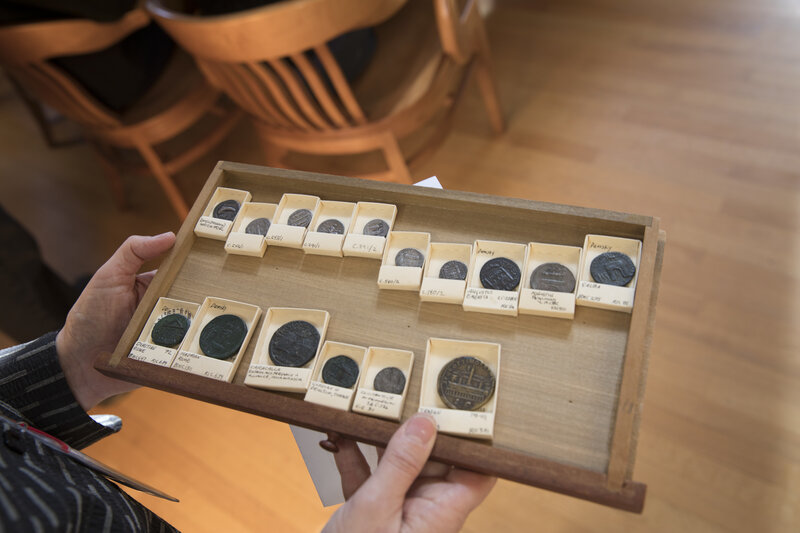 Coins in a wooden tray.