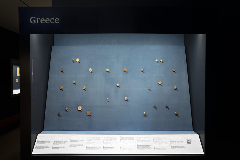 Views of display case with Greek coins.