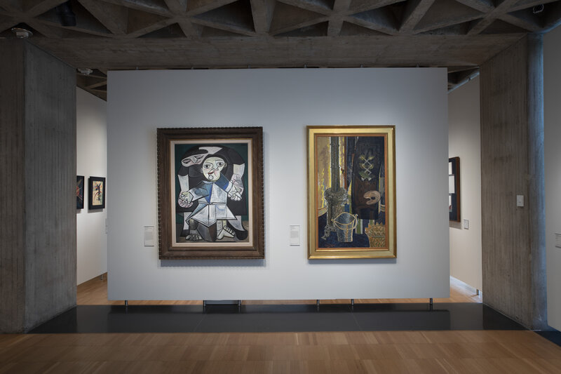 View of two large paintings hanging side by side on a white wall