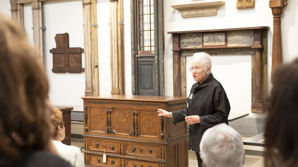 Patricia Kane, curator of American Decorative Arts, leads a tour in the Hume Furniture Study at West Campus