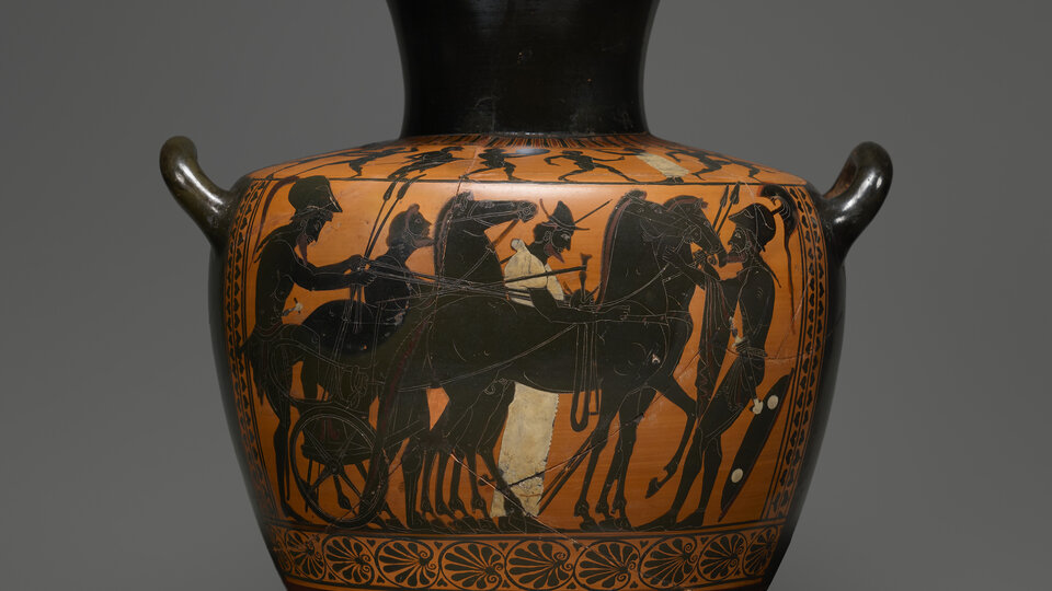 A black vessel with a wide mouth, slightly narrower neck, and a wide body, with a narrower foot. Two small handles protrude from the top of the body. Three-quarters of the body is covered with a processional scene, moving right, above a skinny banded design. The horses and figures of the procession are black, while the background is red. One of the figures, at center, wears a long white garment.