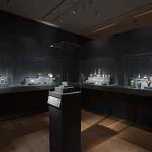 Objects from the collection of ancient glass displayed in glass cases.