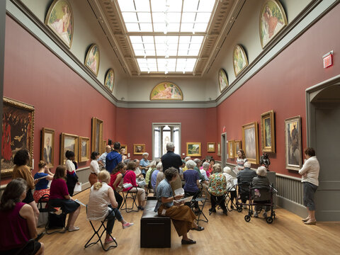 Visitors attending a program in the American art galleries.