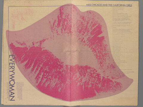 A newspaper or magazine spread depicting a large, pink design resembling lips. A horizontal crease run across the center of the image. Text appears at top left and bottom right.
