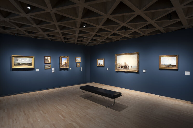 Installation view of In a New Light: Paintings from the Yale Center for British Art, showing paintings on dark blue walls