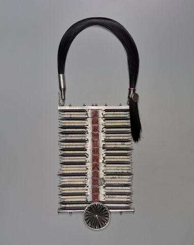 Neckpiece made of repurposed items, including pencils and wooden printing blocks.